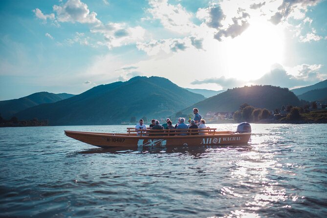 Wine tasting on traditional wooden boats in Wachau Valley - Dürnstein Castle and the blue-and-white town